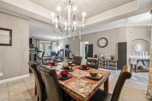1872 Eloise Cove Dr, Winter Haven, FL 33884 - dining space featuring a tray ceiling, light tile patterned flooring, and a chandelier