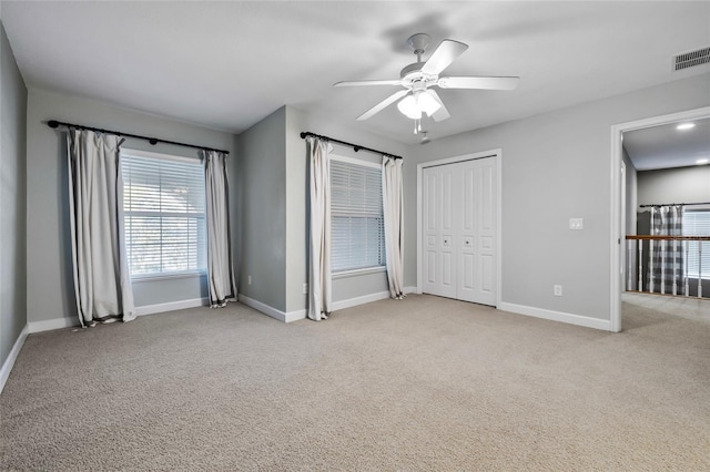 1872 Eloise Cove Dr, Winter Haven, FL 33884 - unfurnished bedroom with light colored carpet, a ceiling fan, and a closet