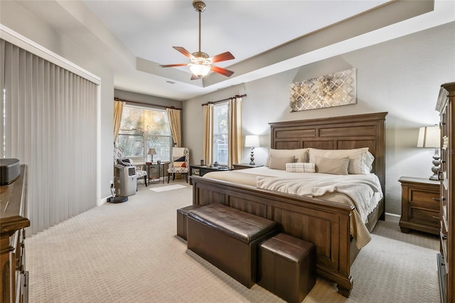 1872 Eloise Cove Dr, Winter Haven, FL 33884 - bedroom featuring light colored carpet, a tray ceiling, and ceiling fan