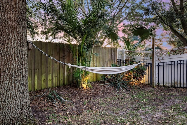 1872 Eloise Cove Dr, Winter Haven, FL 33884 - yard at dusk with a fenced backyard