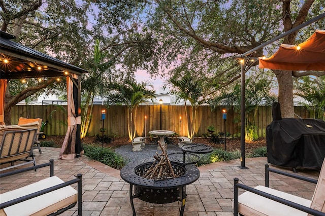 1872 Eloise Cove Dr, Winter Haven, FL 33884 - fenced backyard with area for grilling, a fire pit, a patio area, and a gazebo
