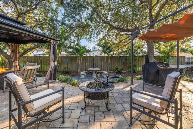 1872 Eloise Cove Dr, Winter Haven, FL 33884 - fenced backyard with a fire pit, a patio, a gazebo, and area for grilling