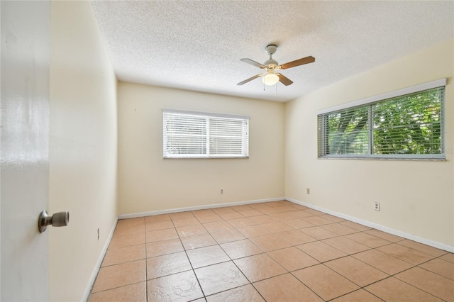 3415 Tricon Ln Unit 13, Holiday, FL 34691 - spare room with ceiling fan, a textured ceiling, and light tile patterned flooring