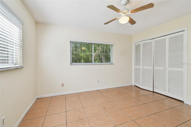 3415 Tricon Ln Unit 13, Holiday, FL 34691 - unfurnished bedroom featuring light tile patterned floors, a closet, and ceiling fan