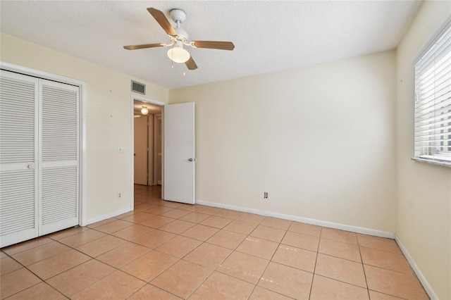 3415 Tricon Ln Unit 13, Holiday, FL 34691 - unfurnished bedroom with a closet, multiple windows, and light tile patterned floors