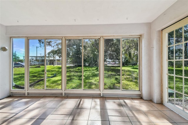 3415 Tricon Ln Unit 13, Holiday, FL 34691 - doorway to outside with healthy amount of natural light and tile patterned floors