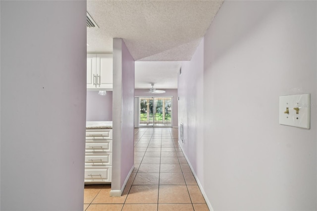 3415 Tricon Ln Unit 13, Holiday, FL 34691 - hallway with light tile patterned floors and a textured ceiling