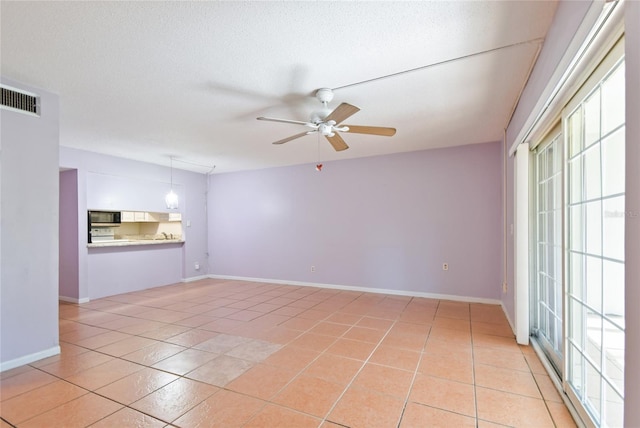 3415 Tricon Ln Unit 13, Holiday, FL 34691 - unfurnished living room with a ceiling fan and light tile patterned floors