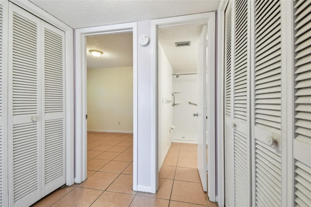 3415 Tricon Ln Unit 13, Holiday, FL 34691 - hallway with light tile patterned floors and a textured ceiling