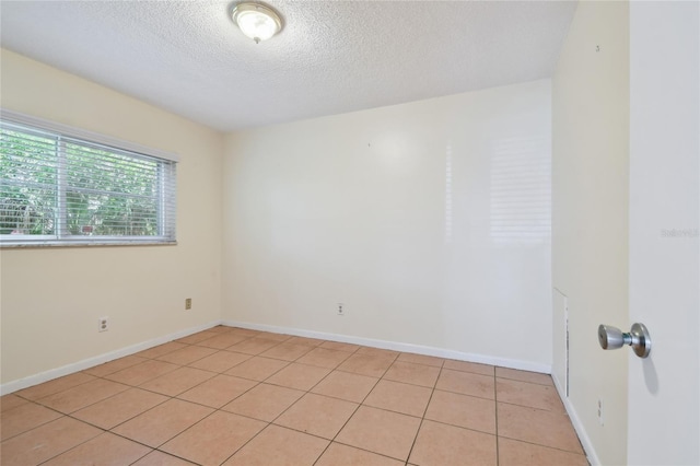 3415 Tricon Ln Unit 13, Holiday, FL 34691 - spare room with a textured ceiling and light tile patterned flooring
