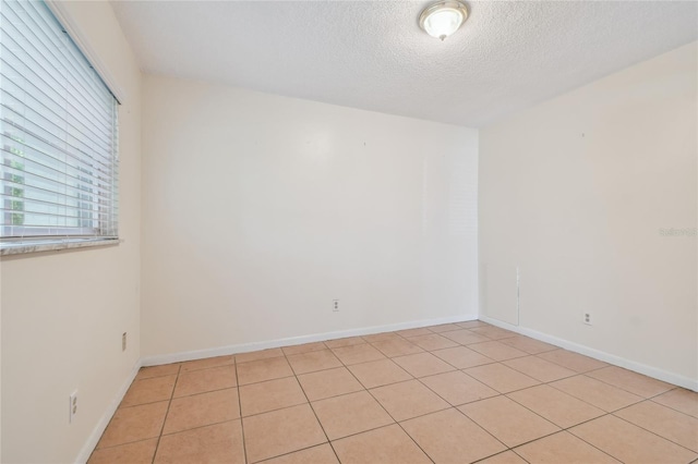 3415 Tricon Ln Unit 13, Holiday, FL 34691 - unfurnished room with a textured ceiling and light tile patterned flooring