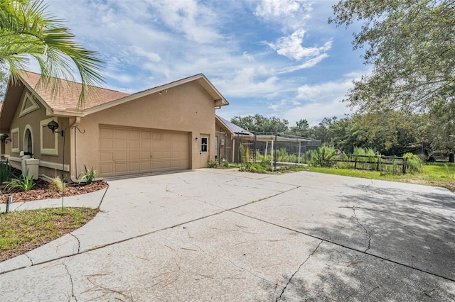 3685 N Palomino Ter, Beverly Hills, FL 34465 - view of home's exterior featuring driveway, stucco siding, and a garage