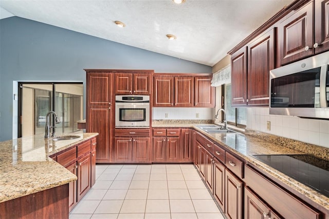 3685 N Palomino Ter, Beverly Hills, FL 34465 - kitchen featuring stainless steel appliances, lofted ceiling, decorative backsplash, light stone counters, and light tile patterned flooring