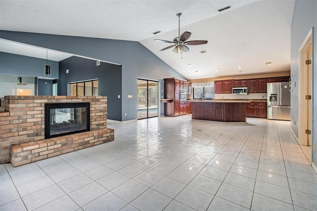 3685 N Palomino Ter, Beverly Hills, FL 34465 - unfurnished living room with a ceiling fan, light tile patterned floors, a brick fireplace, and high vaulted ceiling
