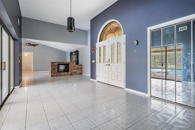 3685 N Palomino Ter, Beverly Hills, FL 34465 - entryway featuring a brick fireplace, a ceiling fan, and a towering ceiling