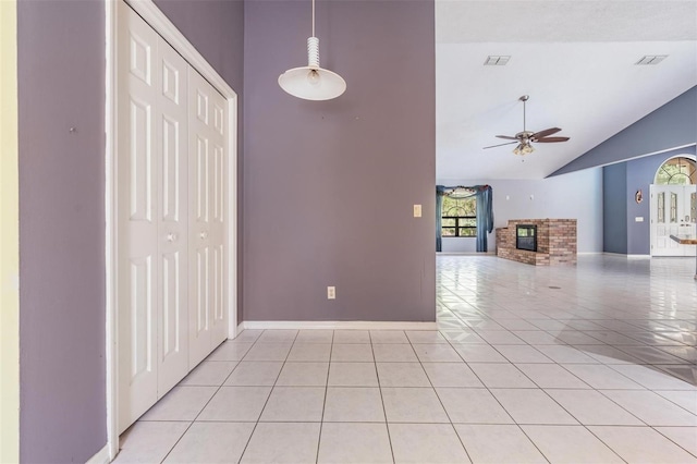 3685 N Palomino Ter, Beverly Hills, FL 34465 - unfurnished living room featuring light tile patterned floors, a ceiling fan, high vaulted ceiling, and a fireplace