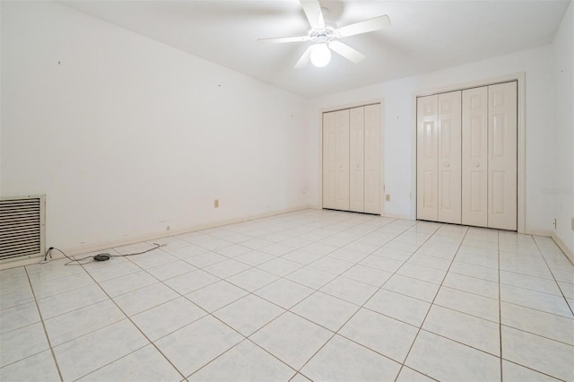3685 N Palomino Ter, Beverly Hills, FL 34465 - unfurnished bedroom with multiple closets, ceiling fan, and light tile patterned floors