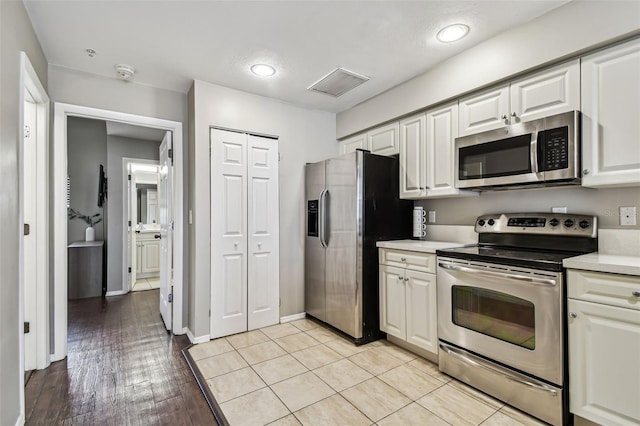 1914 E 4th Ave Unit 2, Tampa, FL 33605 - kitchen featuring stainless steel appliances, light countertops, white cabinets, recessed lighting, and light wood-style floors