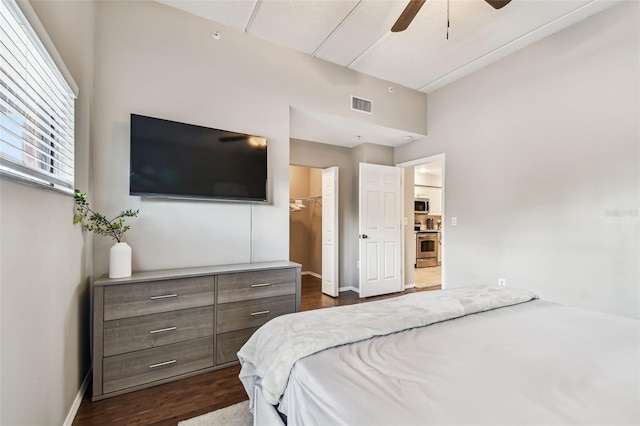 1914 E 4th Ave Unit 2, Tampa, FL 33605 - bedroom with a spacious closet, dark wood-style flooring, and a ceiling fan