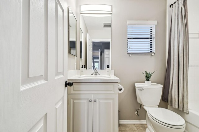 1914 E 4th Ave Unit 2, Tampa, FL 33605 - bathroom featuring vanity, tile patterned flooring, and shower / tub combo with curtain
