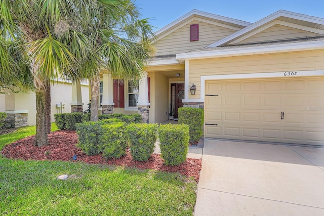 6307 Shadowlake Dr, Apollo Beach, FL 33572 - view of front of home with stone siding, driveway, and an attached garage