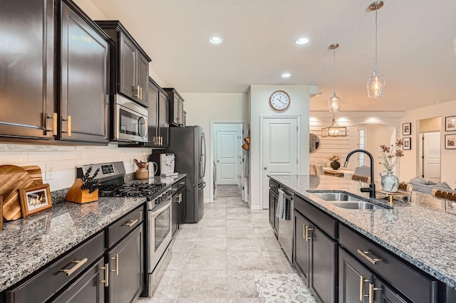 6307 Shadowlake Dr, Apollo Beach, FL 33572 - kitchen featuring appliances with stainless steel finishes, tasteful backsplash, hanging light fixtures, stone countertops, and recessed lighting