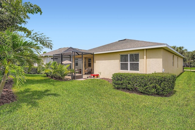 6307 Shadowlake Dr, Apollo Beach, FL 33572 - back of property with stucco siding, a lawn, a patio, and a lanai