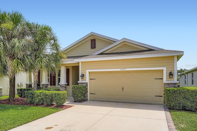 6307 Shadowlake Dr, Apollo Beach, FL 33572 - view of front of house featuring stone siding, driveway, and an attached garage