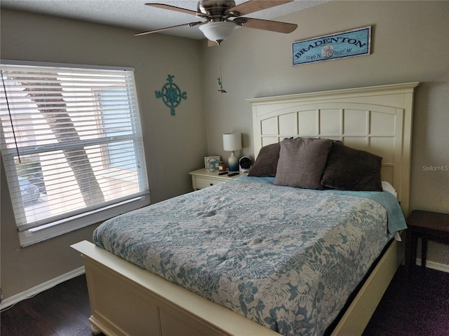 6356 7th Ave W Unit 6356, Bradenton, FL 34209 - bedroom featuring multiple windows, dark wood-type flooring, and a ceiling fan