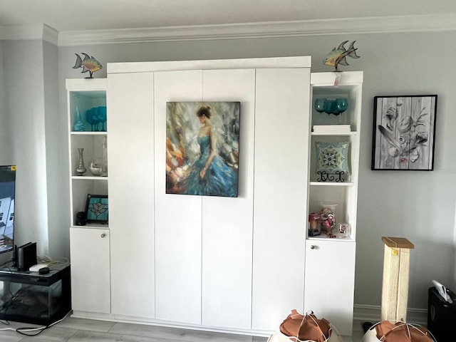 880 Mandalay Ave Unit C206, Clearwater, FL 33767 - living area featuring ornamental molding, built in shelves, and light wood-type flooring
