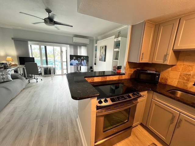 880 Mandalay Ave Unit C206, Clearwater, FL 33767 - kitchen with stainless steel electric range, crown molding, open floor plan, a wall unit AC, and black microwave