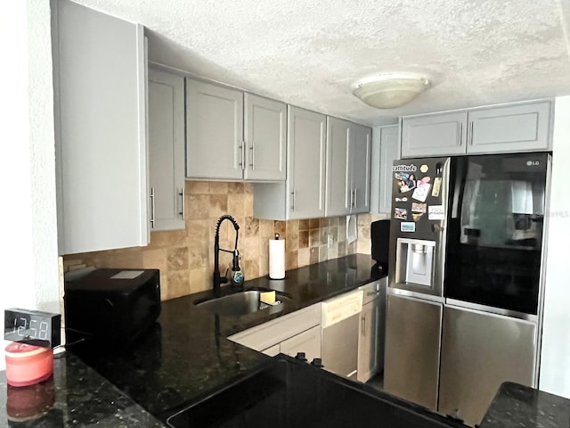 880 Mandalay Ave Unit C206, Clearwater, FL 33767 - kitchen with freestanding refrigerator, decorative backsplash, a textured ceiling, dishwasher, and gray cabinets