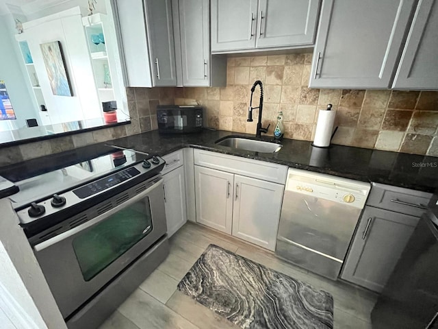 880 Mandalay Ave Unit C206, Clearwater, FL 33767 - kitchen featuring stainless steel appliances, tasteful backsplash, and dark stone countertops