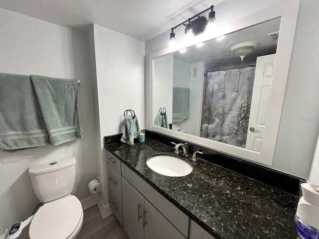 880 Mandalay Ave Unit C206, Clearwater, FL 33767 - full bathroom featuring vanity, a textured ceiling, and a shower with shower curtain