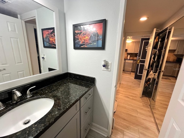 880 Mandalay Ave Unit C206, Clearwater, FL 33767 - bathroom with wood finished floors, vanity, and recessed lighting