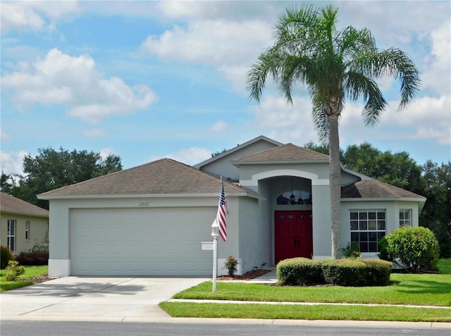 11802 Aintree Ct, Trinity, FL 34655 - ranch-style house featuring stucco siding, concrete driveway, an attached garage, and a front yard