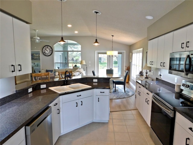 11802 Aintree Ct, Trinity, FL 34655 - kitchen featuring appliances with stainless steel finishes, lofted ceiling, hanging light fixtures, a ceiling fan, and light tile patterned floors