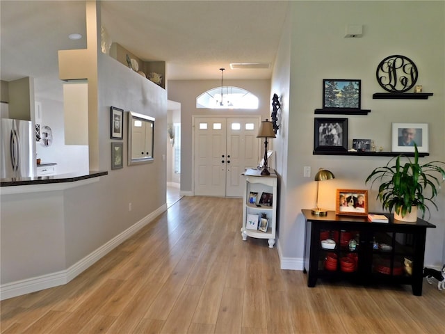 11802 Aintree Ct, Trinity, FL 34655 - entrance foyer featuring a chandelier and wood finished floors