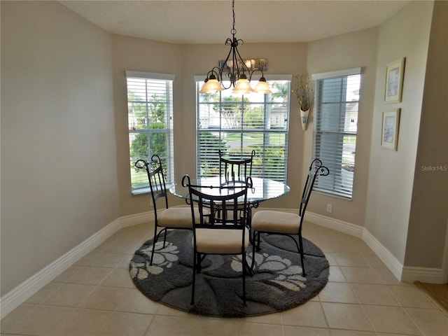 11802 Aintree Ct, Trinity, FL 34655 - dining area featuring light tile patterned flooring, plenty of natural light, and a chandelier