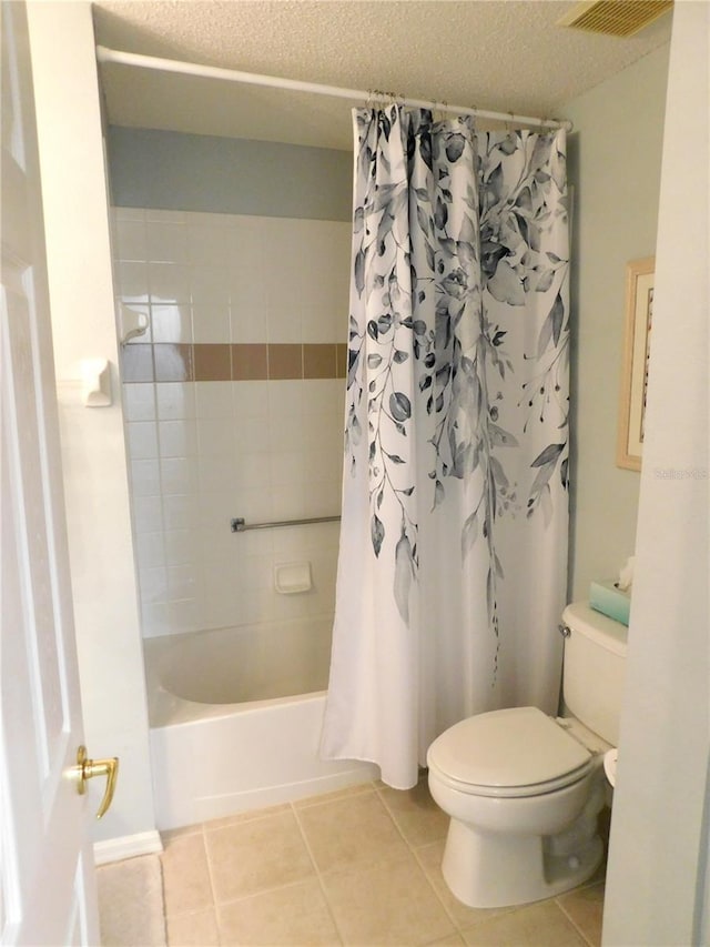 11802 Aintree Ct, Trinity, FL 34655 - full bath featuring tile patterned floors, shower / tub combo with curtain, and a textured ceiling
