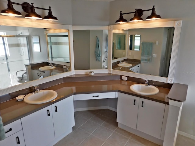 11802 Aintree Ct, Trinity, FL 34655 - bathroom with two vanities, tile patterned floors, and a stall shower