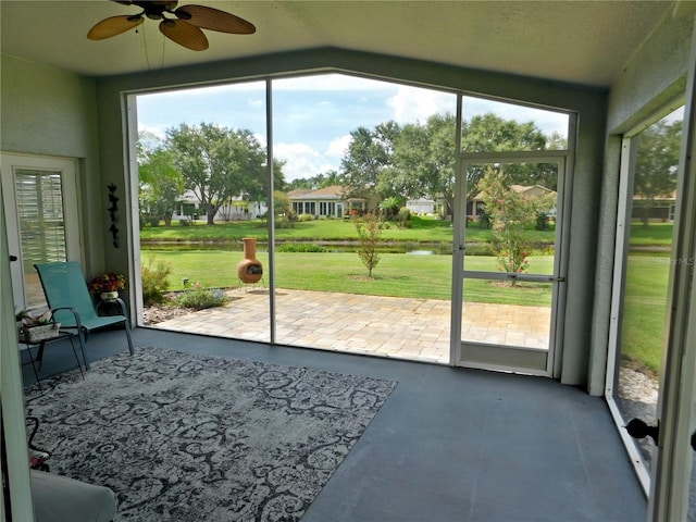 11802 Aintree Ct, Trinity, FL 34655 - doorway with ceiling fan, plenty of natural light, and concrete floors
