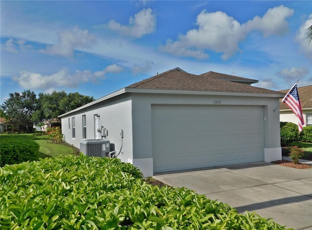 11802 Aintree Ct, Trinity, FL 34655 - view of home's exterior with stucco siding, driveway, roof with shingles, and an attached garage