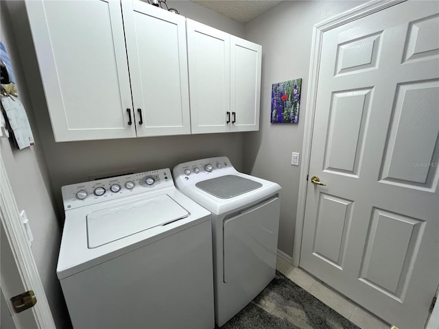 11802 Aintree Ct, Trinity, FL 34655 - washroom with washing machine and clothes dryer, cabinet space, and dark tile patterned flooring
