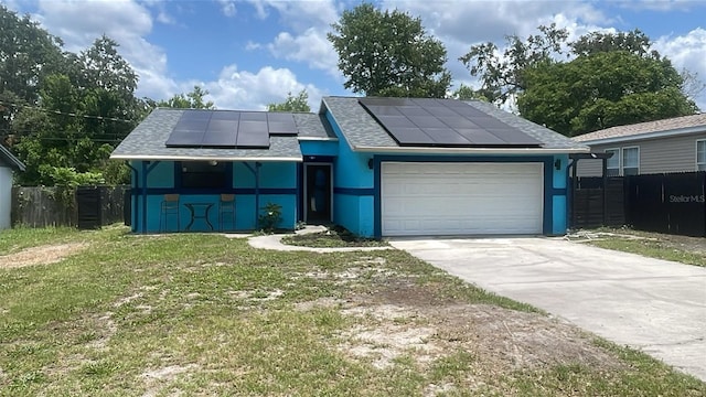 6133 Arthur Ave, New Port Richey, FL 34653 - view of front of property featuring roof mounted solar panels, a garage, concrete driveway, a shingled roof, and stucco siding