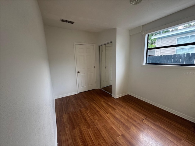 6133 Arthur Ave, New Port Richey, FL 34653 - unfurnished bedroom with wood finished floors and a closet