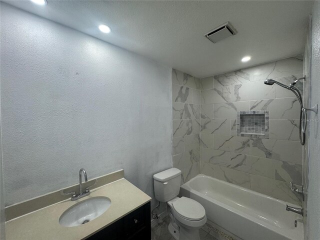 6133 Arthur Ave, New Port Richey, FL 34653 - bathroom featuring vanity,  shower combination, recessed lighting, and a textured ceiling