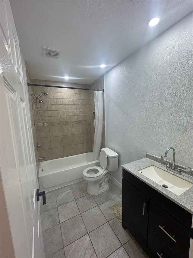 6133 Arthur Ave, New Port Richey, FL 34653 - bathroom with vanity, shower / tub combo, a textured wall, tile patterned flooring, and a textured ceiling