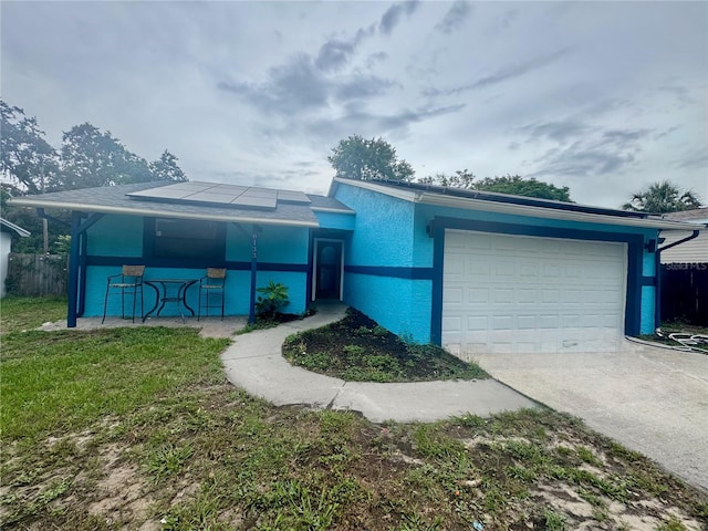 6133 Arthur Ave, New Port Richey, FL 34653 - single story home featuring an attached garage, driveway, stucco siding, and solar panels