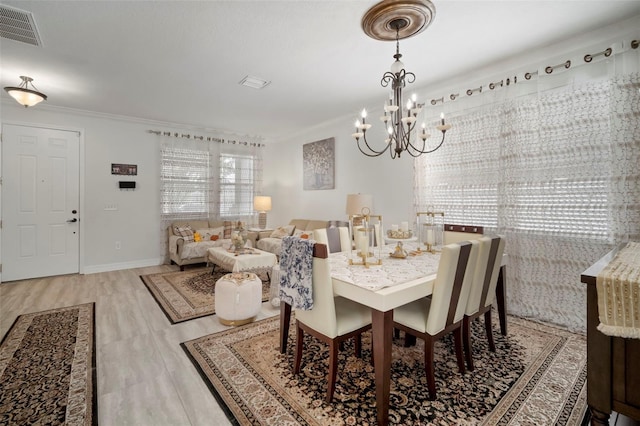 11132 Running Pine Dr, Riverview, FL 33569 - dining space featuring a chandelier, ornamental molding, and wood finished floors